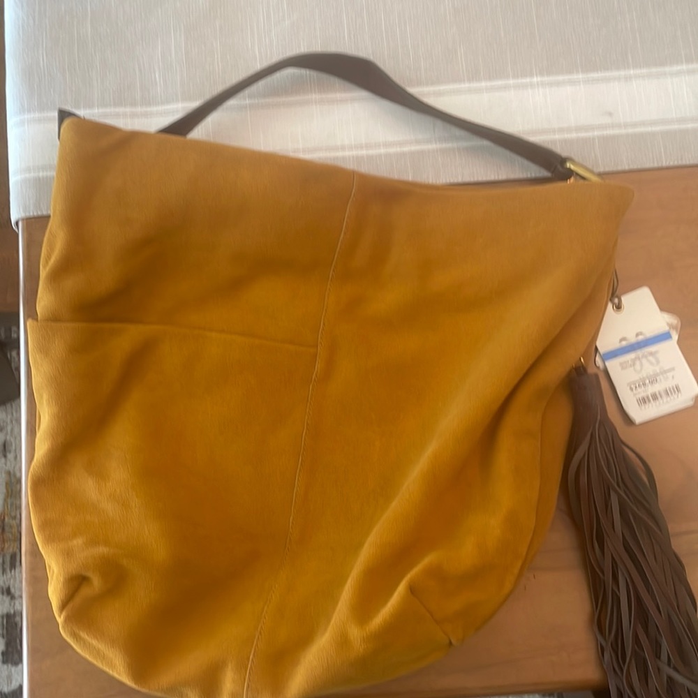 Hobo shoulder bag, camel color with brown tassel embellishment.  New with Tag